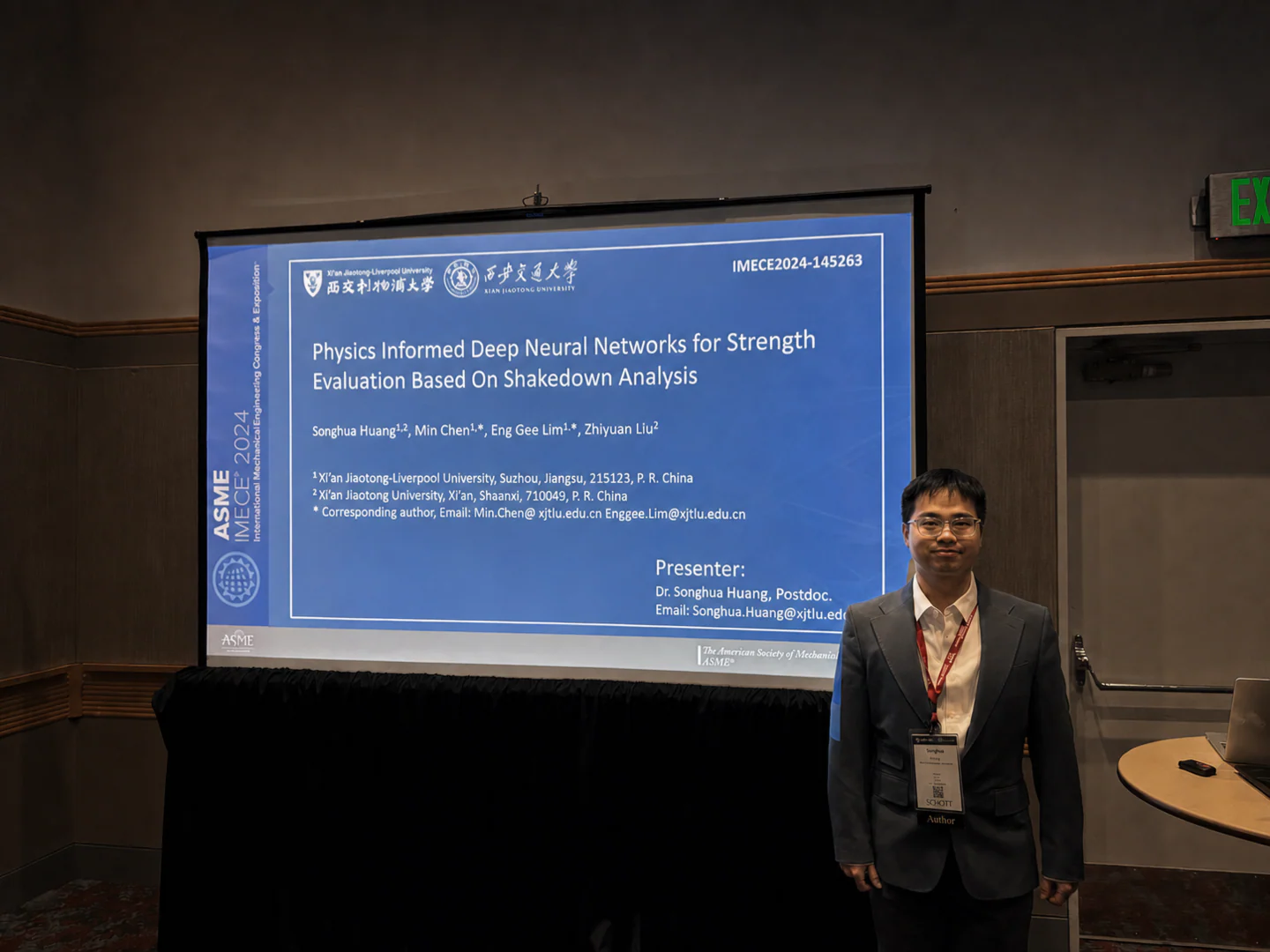 Songhua Huang beside the presentation poster screen at ASME IMECE 2024 in Portland
